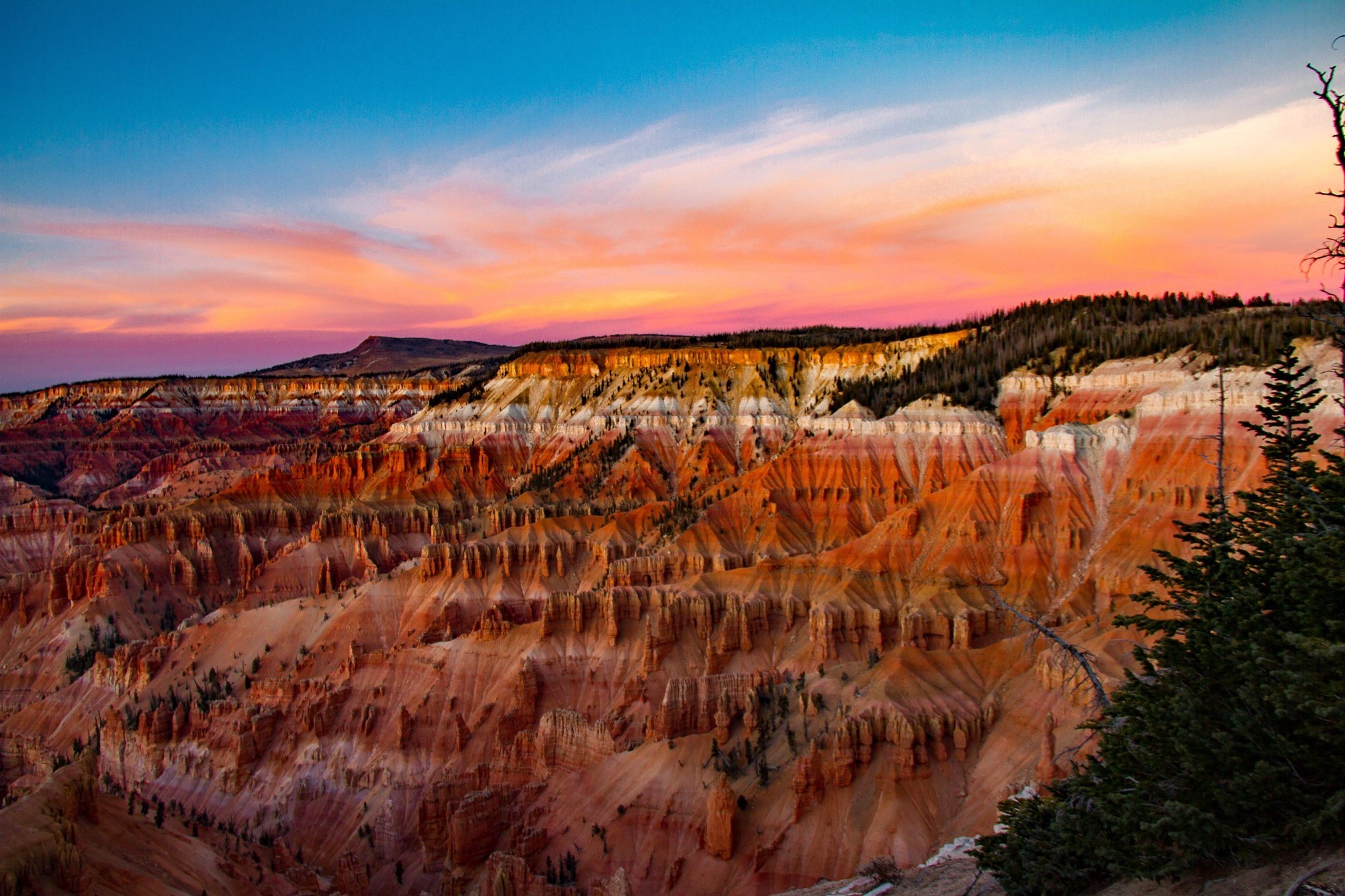 Wide sunset view over the colorful Cedar Breaks amphitheater